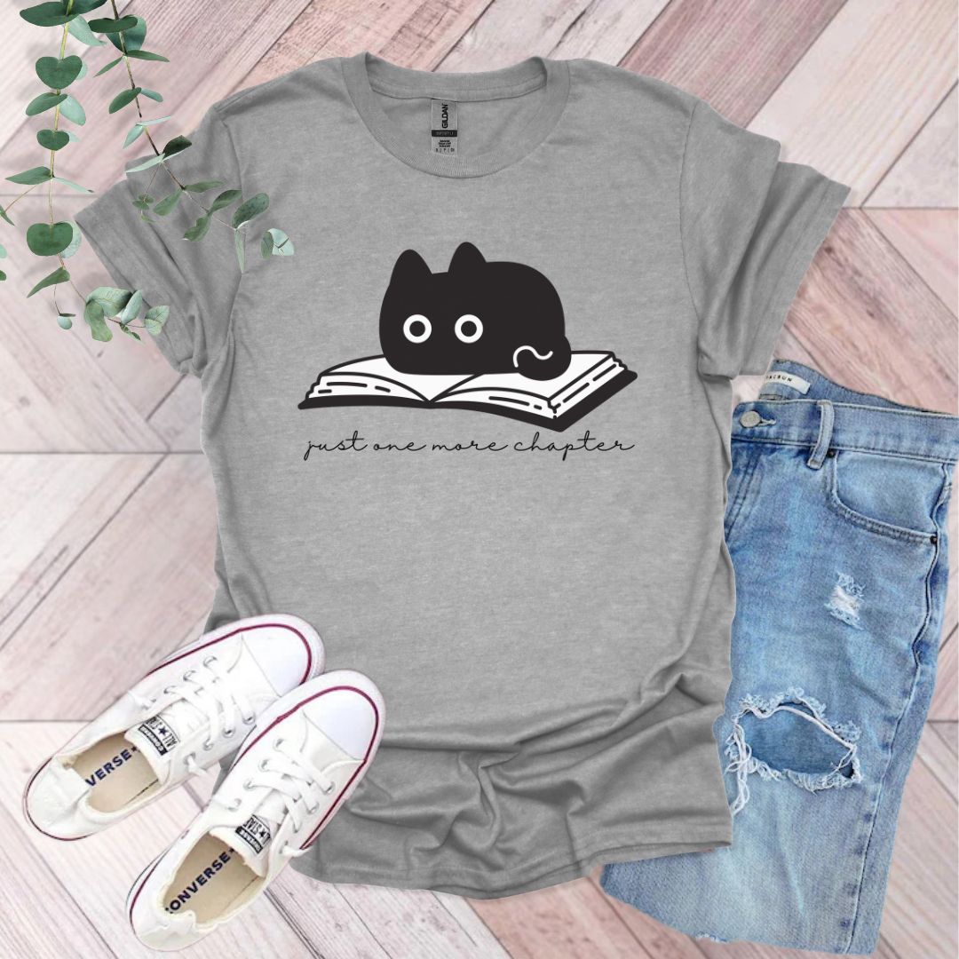 a t - shirt with an image of a cat reading a book