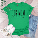 a green shirt that says dog mom university next to a pair of jeans