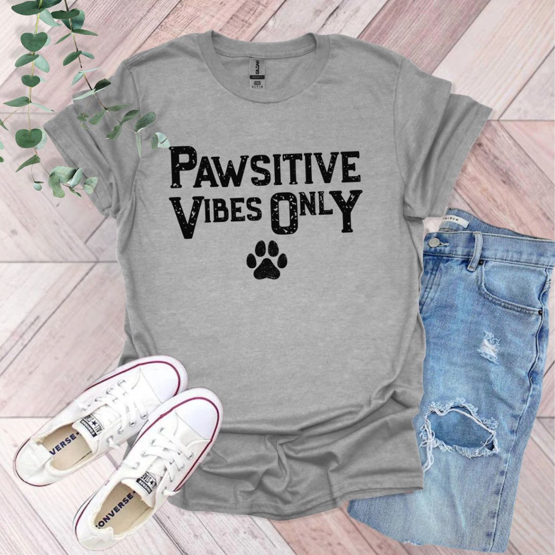 a t - shirt that says pawstive vibes only with a paw print on