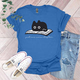 a blue shirt with a black cat reading a book