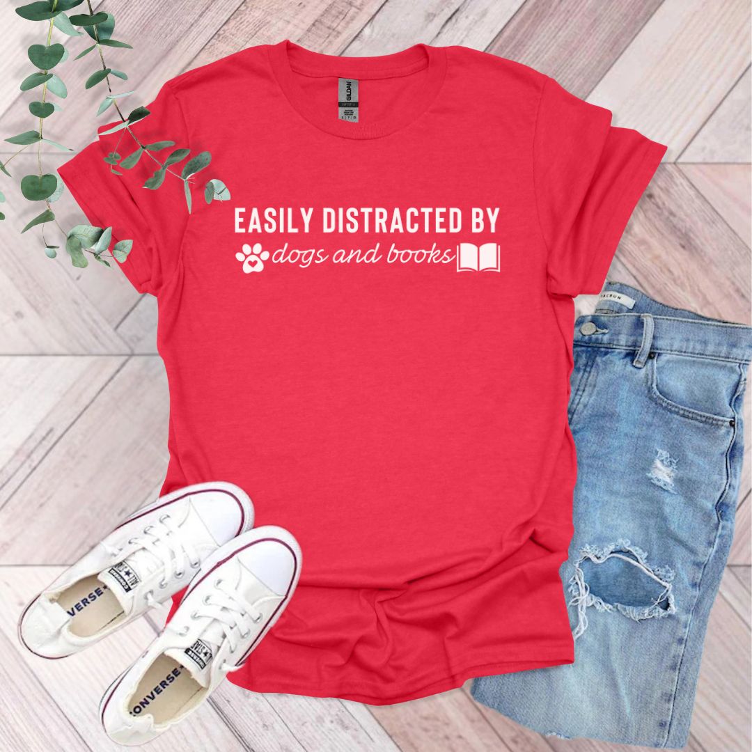 a red t - shirt that says easily distracted by dogs and books