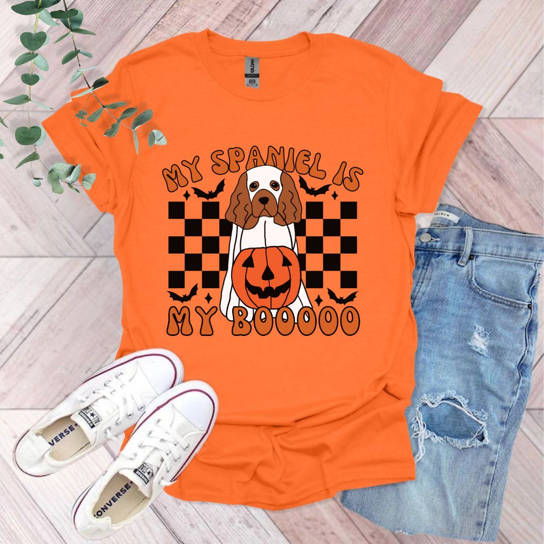 an orange shirt with a dog wearing a jack o lantern