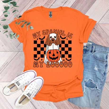 an orange shirt with a dog wearing a jack o lantern